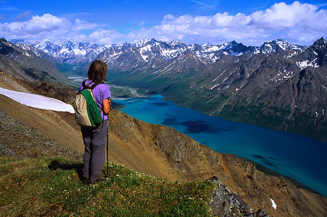 A hiker takes in the view from an overlook above Twin Lakes in Lake Clark National Park and Preserve, Alaska