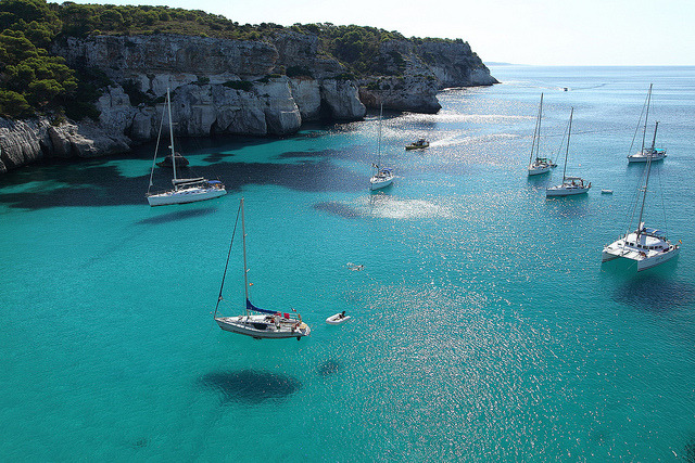 The blue transparent waters of Cala Macarella, Minorca Island, Spain